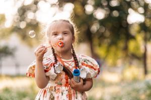 Child with Down Syndrome Blowing Bubbles
