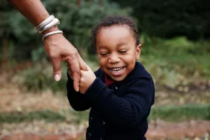 Teacher holding child's hand