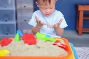 Young Boy Playing with Sensory Bin