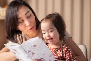 Teacher Reading to a Child with Special Needs